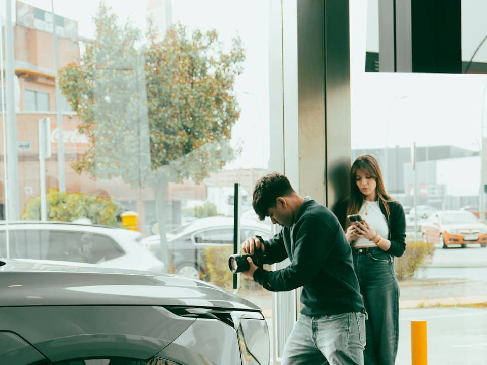 A couple looking at a car in a showroom