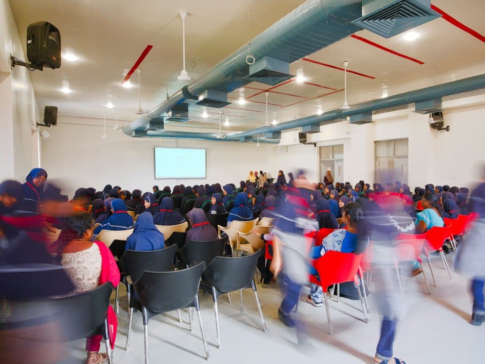 People gathering at a workshop in a hall