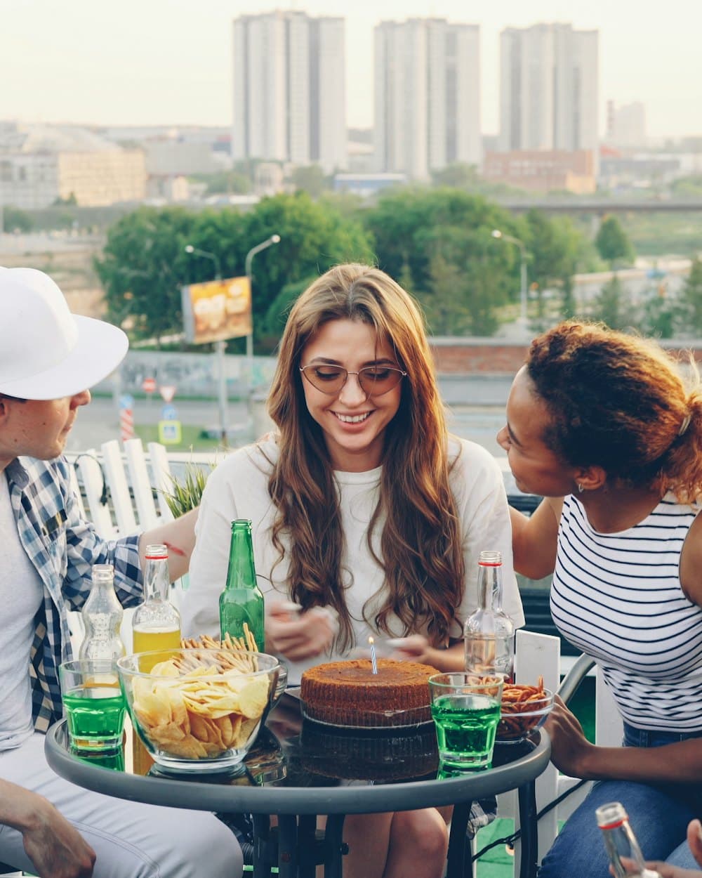 Friends laughing together at a rooftop party
