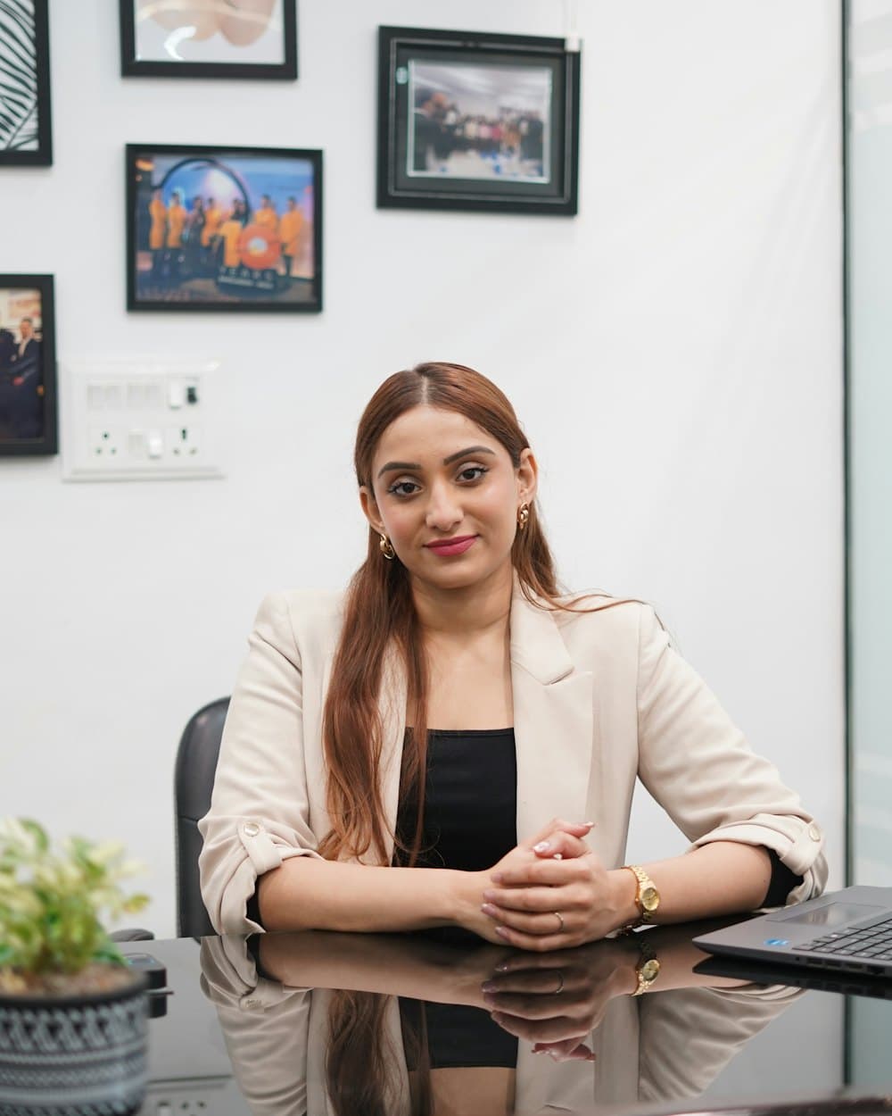 A smiling professional sitting at her office desk